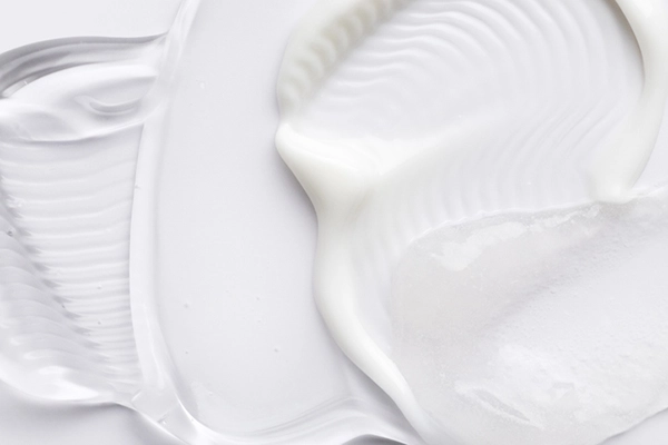 Close-up of clear gel and white cream – liquid and semi-solid medical devices.